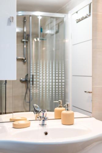 a bathroom with a sink and a shower at Emmy i Alice in Josipdol