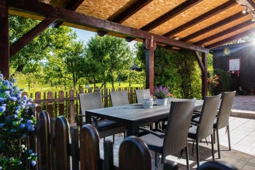 a wooden table and chairs on a patio at Emmy i Alice in Josipdol