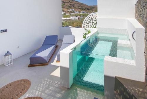 a house with a swimming pool and a swimming poolvisorvisor at Oro Suites in Kinion