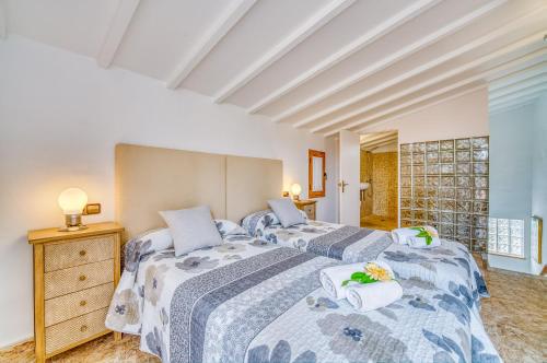 a bedroom with two beds and a dresser at Ideal Property Mallorca - Verdera in Maria de la Salut