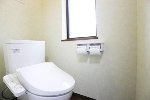 a bathroom with a white toilet and a window at 志摩の別荘 in Shima