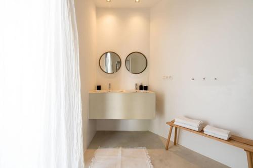 a bathroom with a sink and two mirrors at Loft van 90 m² met grote binnentuin. in Antwerp