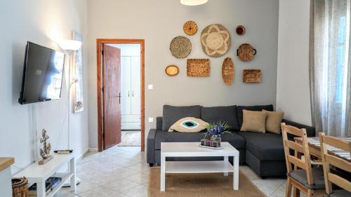 a living room with a couch and a table at Ritzi Apartment in Symi