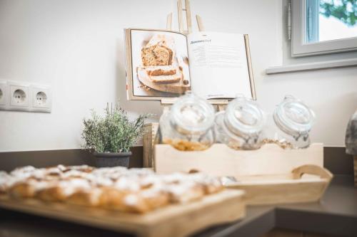 a table with a bunch of pastries in jars on it at Schloss Haindorf in Langenlois