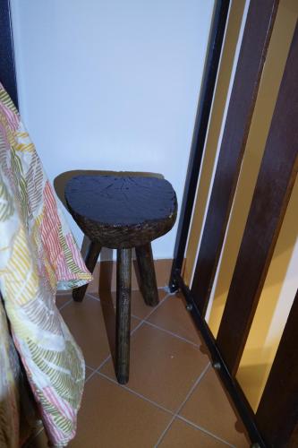 a stool sitting on a floor next to a door at SAILA Monolocale SATURNO in Attigliano