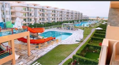 uma vista para um resort com uma piscina em شاليه 120/202 مارينا دلتا em Al Ḩammād