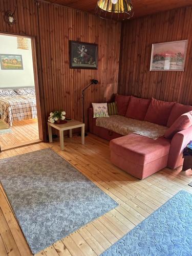 uma sala de estar com um sofá vermelho e uma mesa em Vallaku Guesthouse em Pala