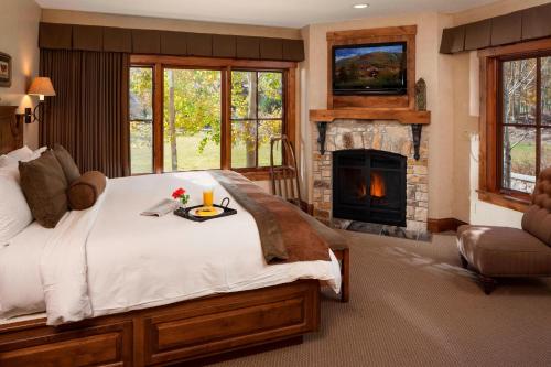 a bedroom with a large bed and a fireplace at Hotel Park City, Autograph Collection in Park City