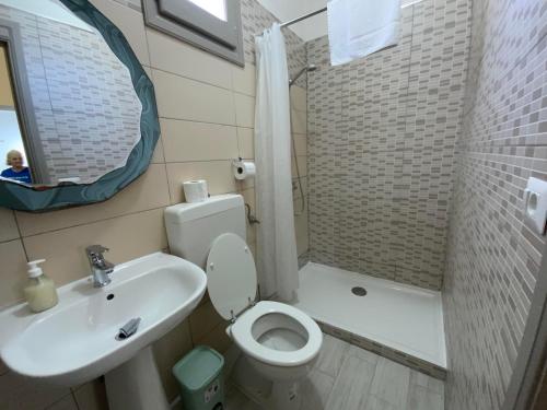 a bathroom with a toilet and a sink and a shower at 3 Mini Studios in Siniscola in Siniscola