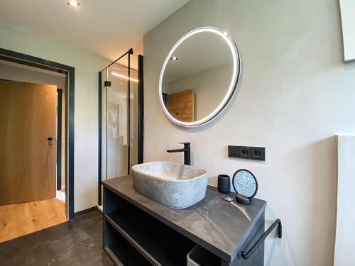 a bathroom with a sink and a mirror on the wall at Bergidyll in Oberstaufen