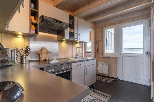 a kitchen with a sink and a stove top oven at Nordseenest am Deich in Wesselburenerkoog