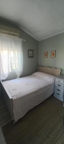 Un pat sau paturi într-o cameră la Εξοχικό ROXANI
