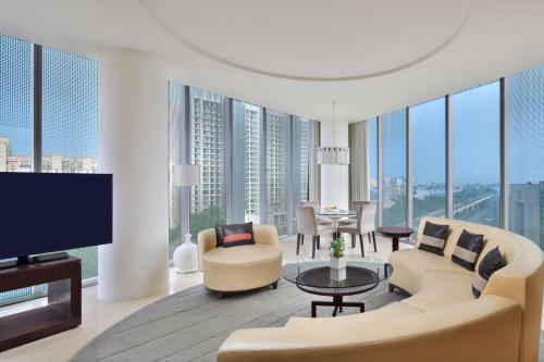 a living room with a couch and a tv at The Westin Gurgaon, New Delhi in Gurgaon