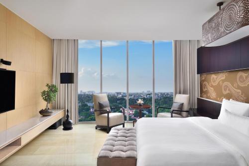a hotel room with a bed and a large window at The Westin Gurgaon, New Delhi in Gurgaon