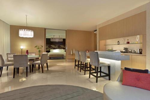 a dining room and kitchen with a dining table and chairs at The Westin Gurgaon, New Delhi in Gurgaon