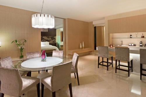 a kitchen and dining room with a table and chairs at The Westin Gurgaon, New Delhi in Gurgaon