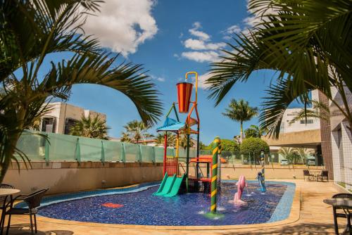 a pool with a water park with children playing in it at Garbos Trade Hotel in Mossoró