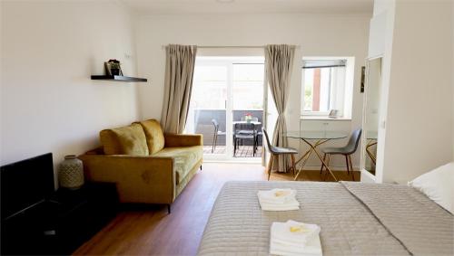 a living room with a couch and a table at Apartment Ajuda Tagus (ground floor) in Lisbon