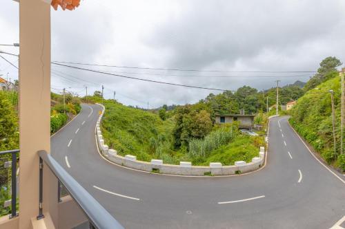 a winding road from a balcony of a house at Ilha Natura in Santana