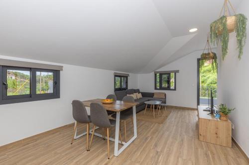 a dining room and living room with a table and chairs at Ilha Natura in Santana