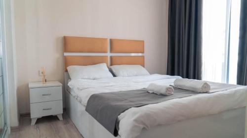 a bedroom with a bed with two pillows on it at Kardinia Hotel in Mezitli