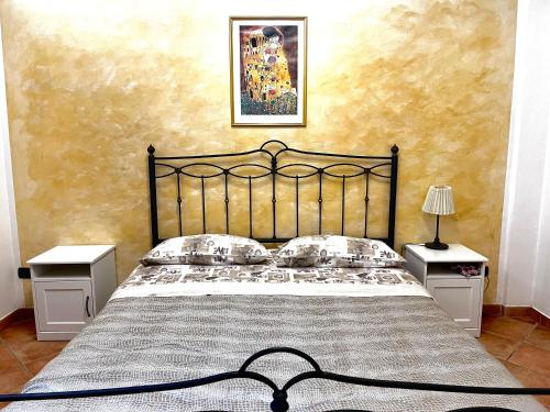 a bedroom with a black bed with two night stands at B&B Civico 28 in Mercato San Severino