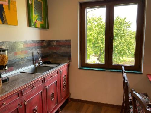 a kitchen with a sink and a window at Ozium in Villa Vicentina