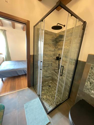 una ducha con puerta de cristal en un dormitorio en Ozium, en Villa Vicentina