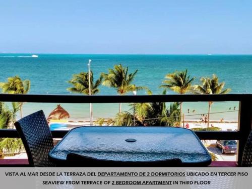 a view of the beach from a balcony with a suitcase at Apartamentos Magali in Cancún