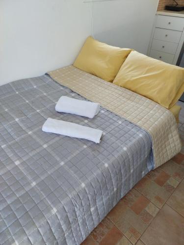 a bed with two white towels on top of it at Small houses anna&sofos in Kardamaina