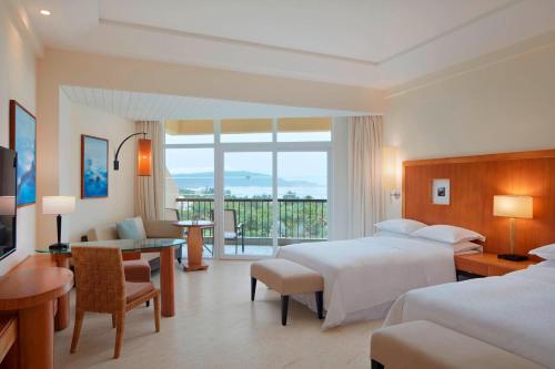 a hotel room with two beds and a balcony at Sheraton Sanya Yalong Bay Resort in Sanya