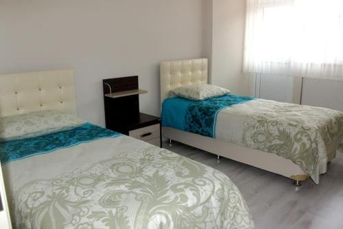 a bedroom with two beds and a window at Star apartments in Trabzon