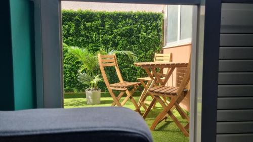 a patio with two chairs and a table on a balcony at Afonso Galo Guest Apartments III in Almada