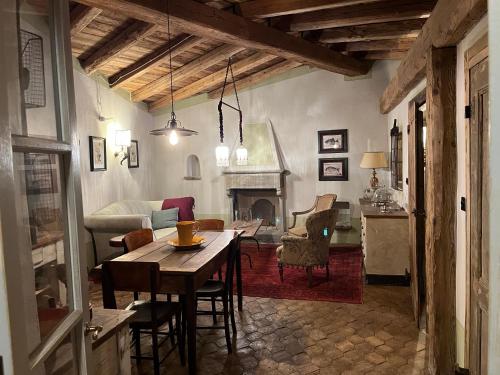 a living room with a table and a fireplace at La Casa sopra il Castello - Portovenere in Portovenere