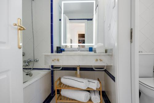 ein Badezimmer mit einem Waschbecken, einem Spiegel und Handtüchern in der Unterkunft SEA VIEW STUDIO I penthouse, beach front urbanization Romana Playa Elviria in Marbella