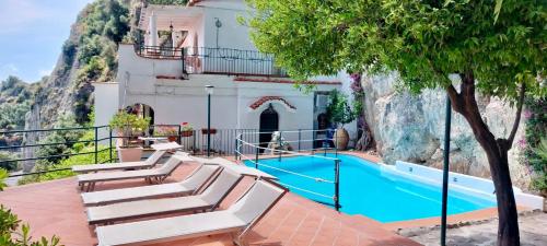 a villa with a swimming pool and a house at Villa Carmela in Conca dei Marini