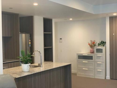 a kitchen with a sink and a counter top at CBD Spacious Two Bedrooms Apartment in Melbourne