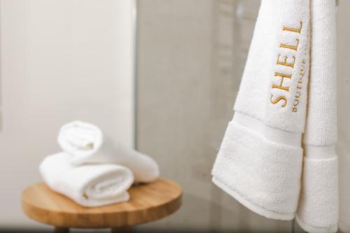 a towel and towels on a cutting board in a bathroom at Boutique Hotel Shell in Budva