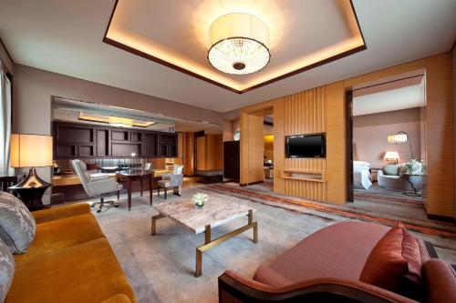a living room with a couch and a table at Sheraton Xi'an North City Hotel in Xi'an