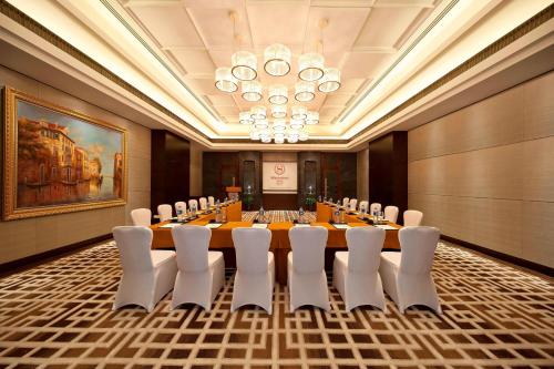 a conference room with a long table and chairs at Sheraton Xi'an North City Hotel in Xi'an