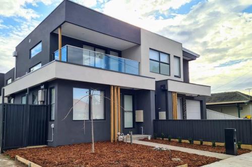 a modern house with a black fence at Sunshine Harmony Retreat (1A) in Sunshine