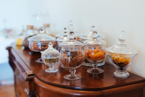 a group of glass bowls with fruit in them on a table at Auberge du Rédier - Logis Hôtels in Colomars