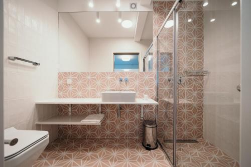 a bathroom with a shower and a sink at Vellamo Dębki in Dębki