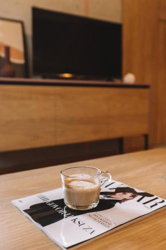 a cup of coffee sitting on top of a table at ZLATIBOR HIGHLAND in Zlatibor
