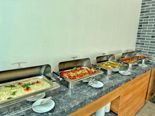 a buffet line with several trays of food at KAYA GARDEN OTEL in Side