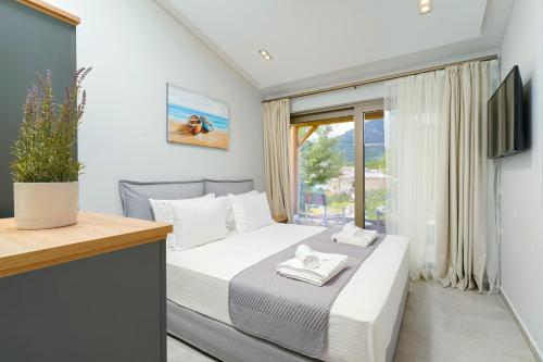 a small bedroom with a bed and a window at Brothers Apartments in Skala Potamias