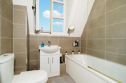 La salle de bains est pourvue de toilettes, d'un lavabo et d'une baignoire. dans l'établissement Pearl Chambers in Leeds City Centre, à Leeds