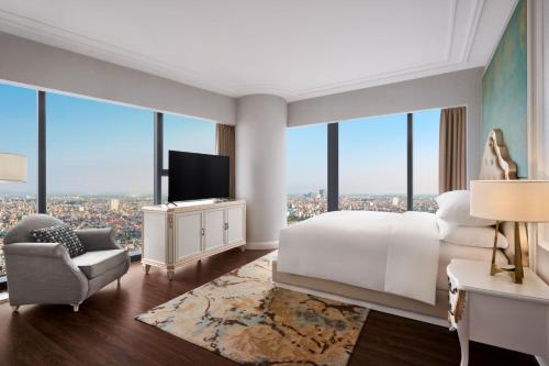 a hotel room with a bed and a tv at Sheraton Hai Phong in Hai Phong