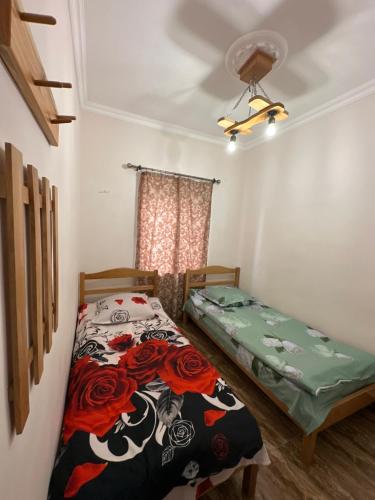 a bedroom with two beds and a window at White House in Yeghegnadzor
