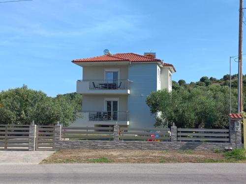 a white house with a fence in front of it at Sandra's luxury stay in Akti Salonikiou